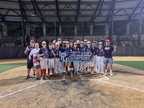 FB Braves team holding a Perfect Game championship banner and medals